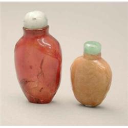 A plain dark honey amber snuff bottle, (crack) 2.25ins; and a honey amber lady's bottle, the side...