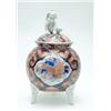 Image 1 : A 19th century Imari porcelain vase, of spherical shape, on three mask feet, domed cover with Dog...