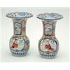 Image 1 : A pair of Japanese Imari vases, with flared and scalloped rims, decorated with panels amid foliag...