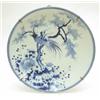 Image 1 : A large 19th century blue and white porcelain charger, decorated with a bird and a blossoming pru...