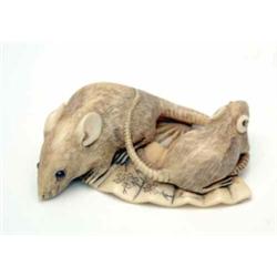 An ivory netsuke, Meiji, two rats on an engraved fan, signed, (one eye missing) 2ins long...