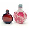 Image 1 : A Chinese red overlay glass snowstorm snuff bottle, carved with bats, double-gourd and ring-handl...