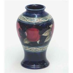A Moorcroft Fruit and Berries baluster jar, early post-war, the continuous horizontal design pain...