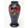 Image 1 : A Moorcroft Pomegranate baluster vase, circa 1910-20, painted against a dark blue ground, impress...