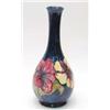 Image 1 : A Moorcroft Hibiscus bottle vase decorated with an encircling band of pink and yellow flower head...