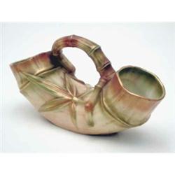 A Royal Worcester ornamental vase, in the form of a bamboo shoot, curved upward with raised handl...