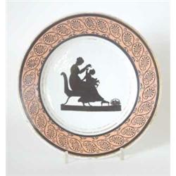 A Coalport hybrid hard paste plate, from the Angerstine service, painted with a seated mother and...