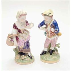 A pair of 19th century French porcelain figures, boy and girl with basket of flowers, on circular...