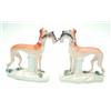 Image 1 : A pair of Victorian Staffordshire whippets, each holding rabbit in mouth, on moulded bases, 7.5in...