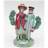 Image 1 : An early 19th century Staffordshire pottery "Dandies" group she with floral garlanded yellow bonn...