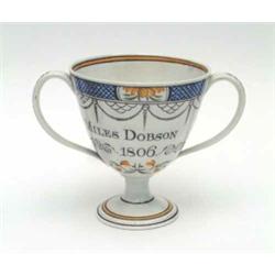 An early 19th century Leeds creamware 2 handled loving cup with blue diaper and floral cartouche...