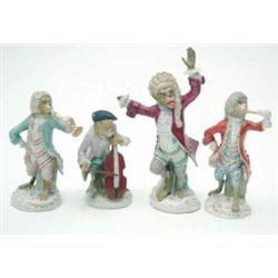 A collection of 4 19th century German porcelain monkey band figures, comprising the conductor, ce...