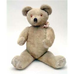 An English Teddy Bear, early post-war, in blonde mohair plush with woodwool and kapok filling, jo...