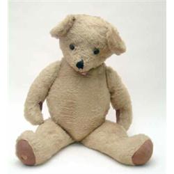A large English Teddy Bear, 1930's, in light brown mohair with stitched snout and jointed limbs,...