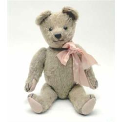 An English Teddy Bear, 1920's, possibly J.K. Farnell, with protruding snout, glass eyes, light br...