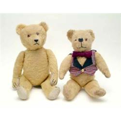 An English bright gold plush Teddy Bear, 1920's, with glass eyes, stitched, protruding snout and...