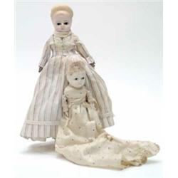 Two late 19th century wax over composition dolls, with glass eyes and peg-wood limbs, clothed. 14...