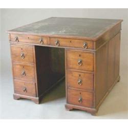 An early 19th century mahogany partners desk of unusually small size with green leather top over...