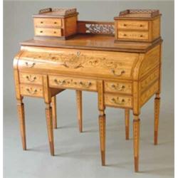 An early 20th century satinwood desk with raised superstructure of drawers separated by a fret wo...