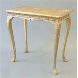 A George I giltwood side table with relief moulded scrolling decoration to the top, over a concav...