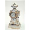Image 1 : A KPM porcelain mantel clock, modelled with urn surmount, mask terminals and floral and ribbon dr...