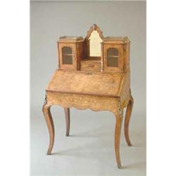 A Victorian inlaid walnut bonheur du jour with central mirror flanked by two glazed doors over a...