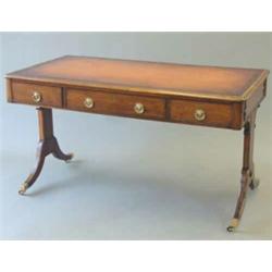 A late 18th century chestnut double sided library table with tan skiver over opposing drawers on...