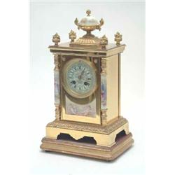 A French late 19th century gilt bronze and porcelain mantel clock, the rectangular case with a pa...