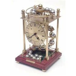 A brass 'Fema' spherical weight clock No. 227, the movement by Sinclair Harding & Co, England, in...