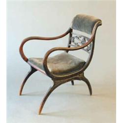 An early Victorian ebonised beech elbow chair with upholstered cresting rail and carved mid rail...