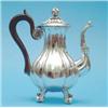 Image 1 : A Continental silver coffee pot, of fluted baluster form with scroll feet and ebonised handle....