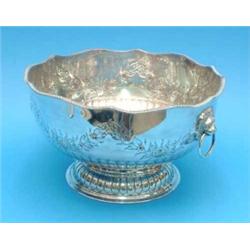 A plated copper punch bowl with lions mask ring handles....