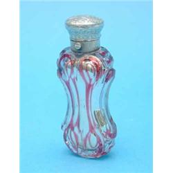 A Victorian silver mounted ruby overlaid glass scent flask with silvered interior and scroll engr...