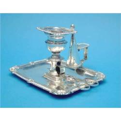 An Old Sheffield plate candlestick of rectangular form, together with a pair of snuffers....