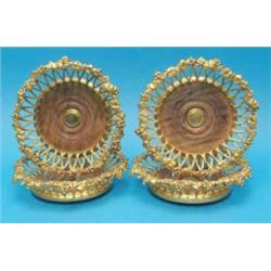 A set of four Elkington & Co gold plated wine coasters, of circular basket form with vineous bord...