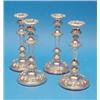 Image 1 : A set of four Victorian plated candlesticks, with scroll and shell banded stems and circular feet...