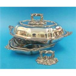 A pair of plated entree dishes and covers, of serpentine oval form....
