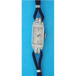 A 1930's ladys diamond set platinum cocktail watch with rectangular Arabic dial....