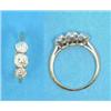 Image 1 : A three stone diamond ring, the old brilliant cut stones claw-set in 18ct gold....