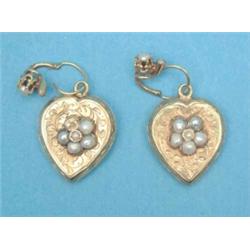 A pair of Victorian foliate engraved gold heart shaped earrings, set seed pearl clusters, the bac...