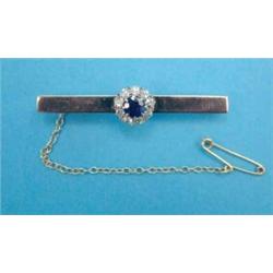 A 9ct gold bar brooch, mounted at the centre with a sapphire and diamond cluster...