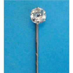 A gold stickpin, claw-set with an old brilliant cut diamond...