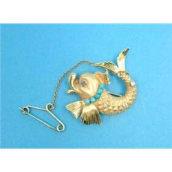 A gold brooch, in the form of a dolphin set diamonds, turquoises and a sapphire...