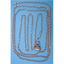 A gold oval link guard chain, and a foliate chased fob seal...