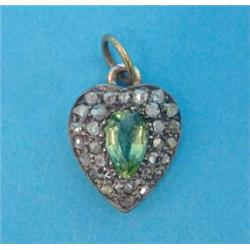 A Victorian heart shaped pendant, pave set with a peridot and rose cut diamonds...