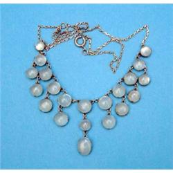 A moonstone fringe necklace, claw set in silver on a tracelink back chain...