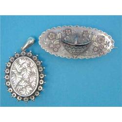 A late Victorian silver pendant locket, with foliate engraved decoration and a similar silver bro...