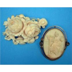 A Victorian ivory brooch, carved with a spray of roses and foliage, together with a simulated ivo...