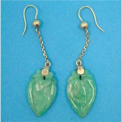 A pair of carved jade drop earrings, on yellow metal trace link suspension...