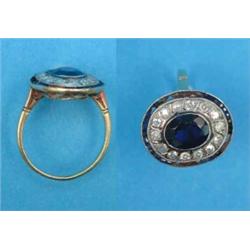 A gold, sapphire and diamond ring, the millegrain set oval sapphire bordered by 14 diamonds and a...